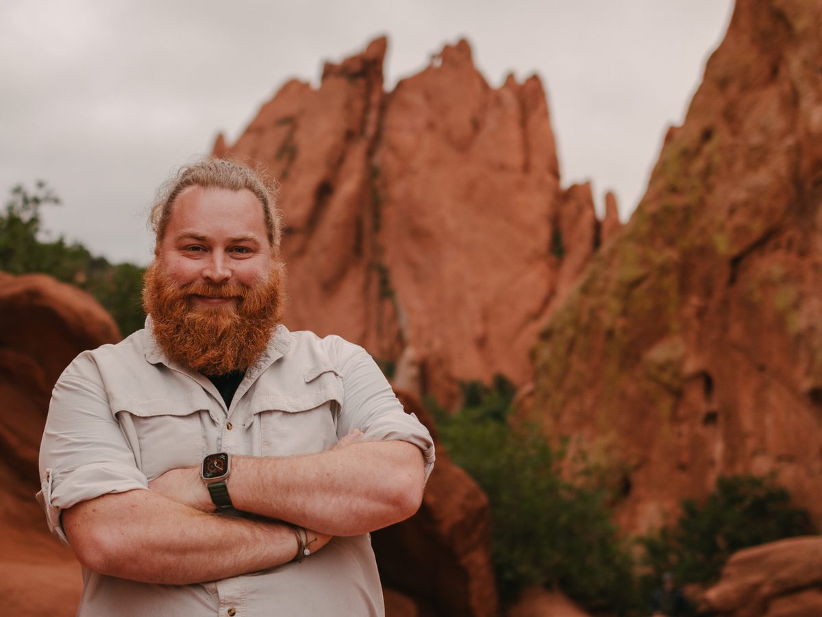 Andy standing in front of red rock formations